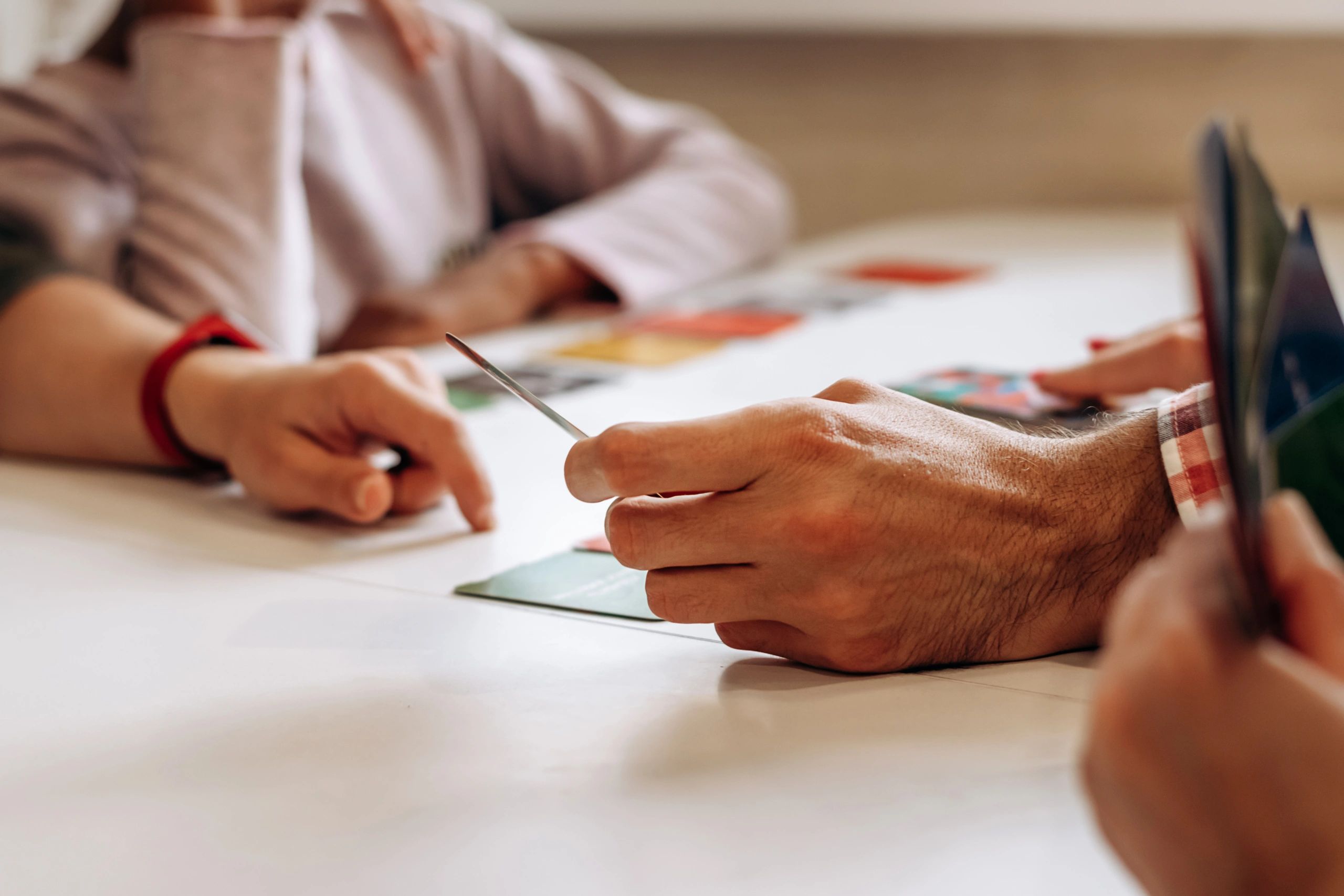 Hands at a tabletop during a game, representing a satisfied buyer