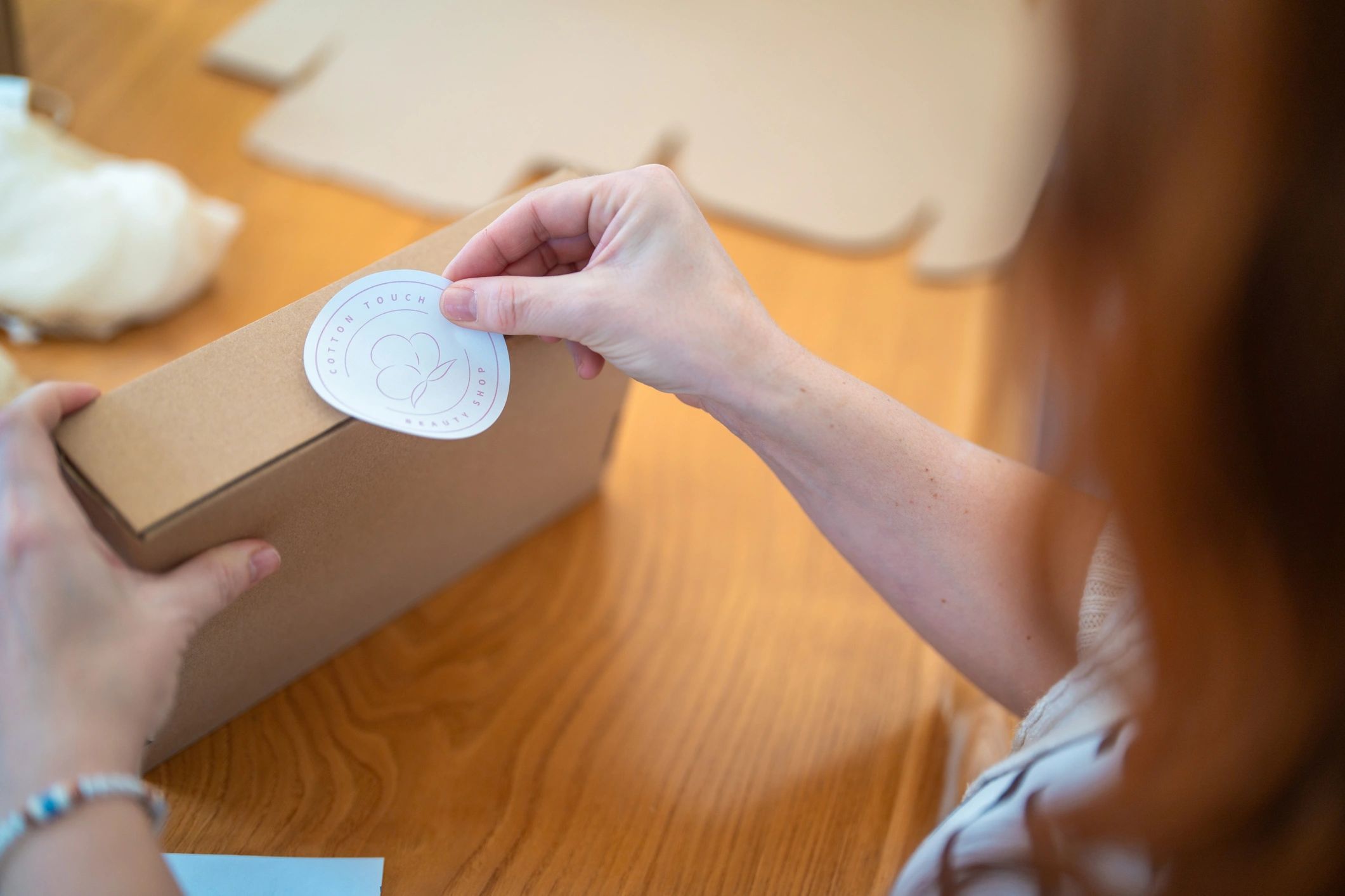 Hands labeling small packages for shipping
